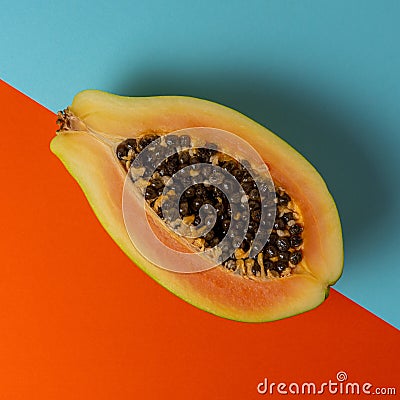 Creative tropical layout with papaya on colorful vivid paper. Minimal abstract summer concept. Flat lay Stock Photo