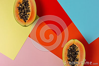 Creative tropical layout with papaya on colorful vivid paper. Minimal abstract summer concept. Flat lay Stock Photo