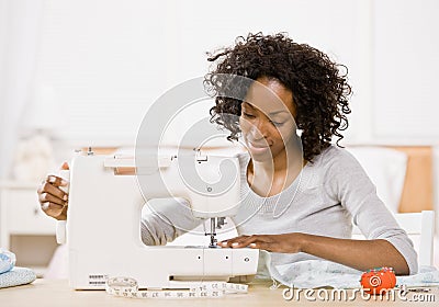 Creative woman using sewing machine Stock Photo