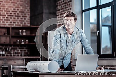 Inspired male engineer finishing work Stock Photo