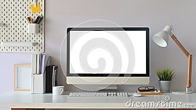 Creative Workspace. White blank screen computer on Office working desk. Equipment on table. Stock Photo