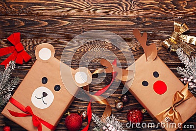 Creatively wrapped Christmas gifts in the shape of a teddy bear and a deer. New Year and Christmas concept. DIY gift wrapping. Stock Photo