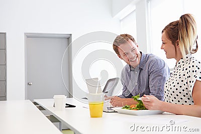 Creatives Having Working Lunch In Design Studio Stock Photo