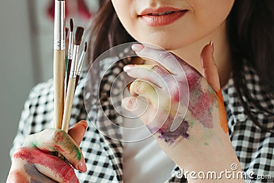 Hands of young woman dirty in watercolor paint Stock Photo