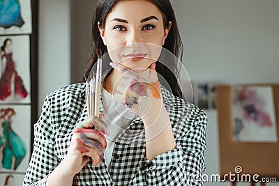 Hands of young woman dirty in watercolor paint Stock Photo