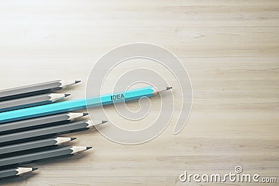 Creativity inspiration and idea concept with row of grey pencils and one blue standing out from the rest on wooden surface Stock Photo