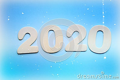 2020. Creativity, of a New concept for the year 2020. Wooden figures and flowers on a colored background. Stock Photo