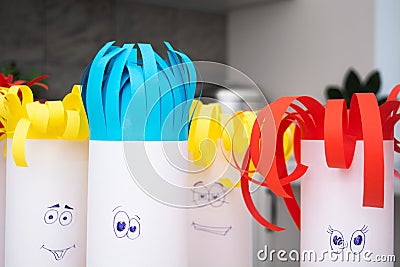 Creativity paper handmade for children. Funny faces on tubes with colorful hair Stock Photo