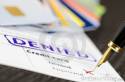 Credit card application close up shot and stamp denied, cards and pen. Stock Photo