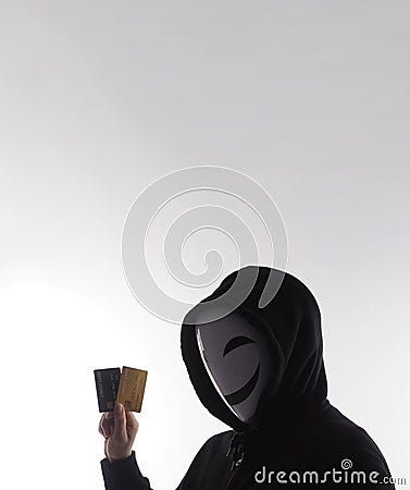 Credit cards personal data stolen by anonymous man in Black hood shirt Stock Photo