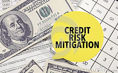 CREDIT RISK MITIGATION words on yellow sticker with dollars and charts Stock Photo