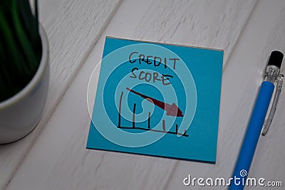 Credit Score write on sticky note on wooden table Stock Photo