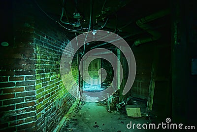 Creepy basement door of a haunted theater basked in Green light Stock Photo