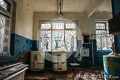 Creepy old laundry room in abandoned hospital Stock Photo