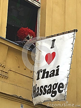 Creepy scary eye-catching commercial marketing with a clown for a Thai massage studio in Praha Editorial Stock Photo