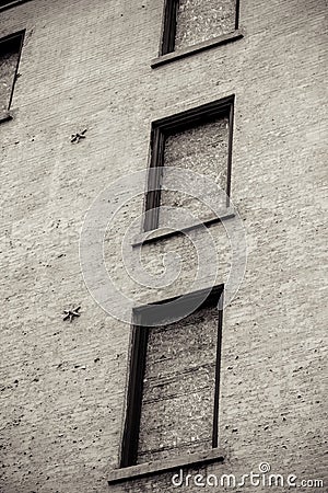 Creepy Vacant building with boarded up windows Stock Photo