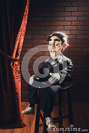 Scary ventriloquist doll sitting on a stool Stock Photo