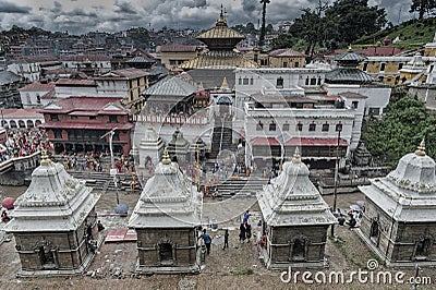 Cremation ceremony along the holy Bagmati River at Pashupatinath Hindu Temple and the Burning Ghats in Kathmandu Nepal - UNESCO. Editorial Stock Photo