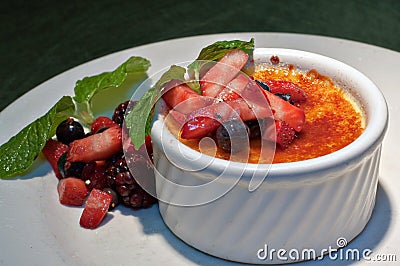 Creme Brulee with fresh fruit and mint sprigs 2 Stock Photo