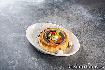 creme caramel served in a dish isolated on dark background side view dessert Stock Photo