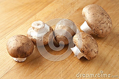 Cremini Mushrooms on Wood Surface Stock Photo