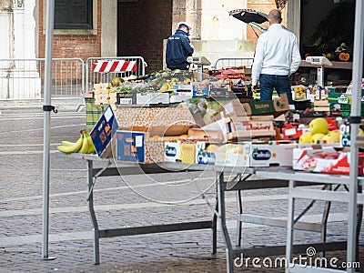 Cremona, Lombardy, Italy - 16 th may 2020 - People grocery shopping socially distance d in local biologic open air food market Editorial Stock Photo