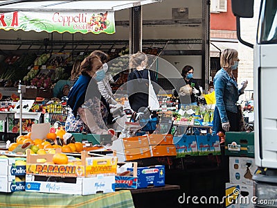 Cremona, Lombardy, Italy - 16 th may 2020 - People grocery shopping socially distance d in local biologic open air food market Editorial Stock Photo