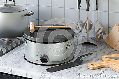 Crepe maker on the kitchen table. 3D rendering Stock Photo