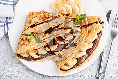 Crepes or blini stuffed with chocolate, banana Stock Photo