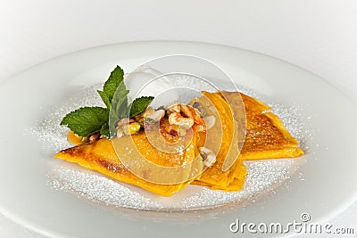 Crepes with Honey,nuts,orange souce and Mint Leaf Stock Photo