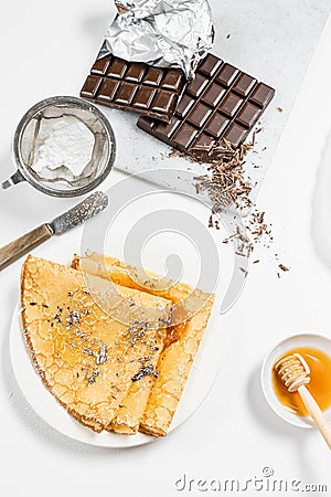 crepes on a plate with honey jam chocolate and sugar Stock Photo