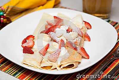 Crepes with strawberry, banana and whip cream Stock Photo