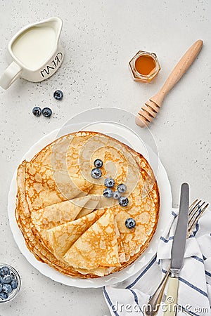 Crepes, thin pancakes or blini with berries in white plate. Top view. Pancake week. Shrovetide. Space for text Stock Photo