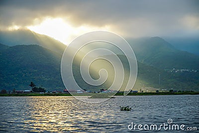 Crepuscular Rays. Sun Shining Through Clouds at Inle Lake in Myanmar Burma Stock Photo
