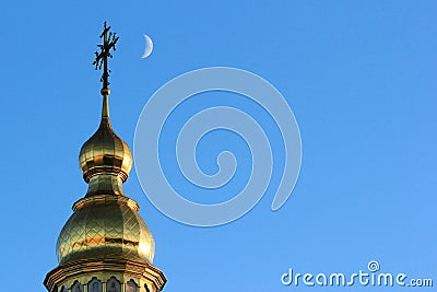 Crescent moon near the cross on top of St. Michael`s Golden-Domed Monastery in Kyiv, Ukraine Stock Photo