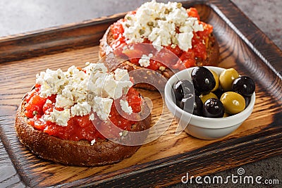 Cretan dakos is for a traditional salad from the island of Crete consists of barley rusk topped with juicy tomatoes, cheese and Stock Photo