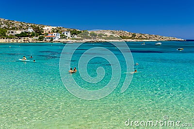 CRETE, GREECE - JULY 01 2023: Swimmers and paddleboarders in the beautiful, clear, shallow waters of Marathi, Chania, Crete Editorial Stock Photo