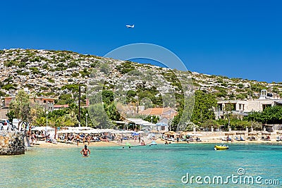 CRETE, GREECE - JULY 01 2023: Swimmers and paddleboarders in the beautiful, clear, shallow waters of Marathi, Chania, Crete Editorial Stock Photo