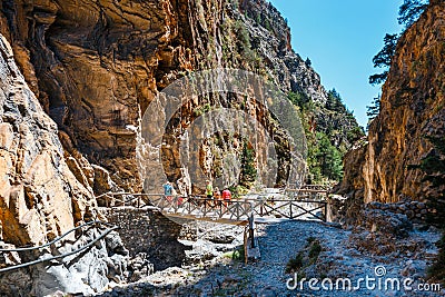 Tourists hike in Samaria Gorge in central Crete, Greece. The national park is a UNESCO Biosphere Rese Editorial Stock Photo