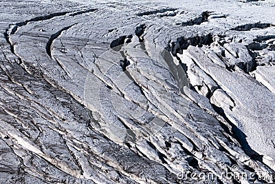 Alpine glacier crevasses exposed on surface in summer Stock Photo