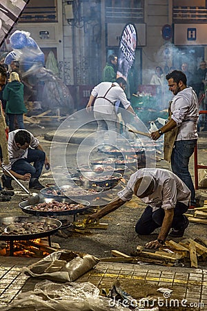 Crew cooking many paellas Editorial Stock Photo