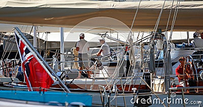 The crew of a luxury sailing ship standing in their ship in palma seaport during the 50th Boatshow fair.a de mallorca seaport wide Editorial Stock Photo