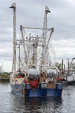 Crewmen watching as commercial fishing boat U-Boys gets ready to dock Editorial Stock Photo