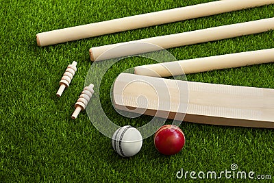 Cricket bat ball stumps and bails placed on green grass cricket pitch background Stock Photo