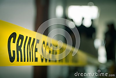 crime concept by police line tape with blurred forensic law enforcement background in cinematic tone Stock Photo