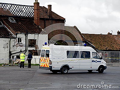 Crime Scene Fire Damaged House with police Stock Photo