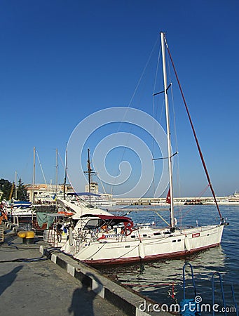 Crimea, Yalta. There are several small yachts at the pier Editorial Stock Photo