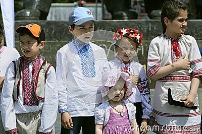 Crimean Tartar and Ukrainian children little boys girls in embroidered shirts singing Ukraine hymn on the street Editorial Stock Photo