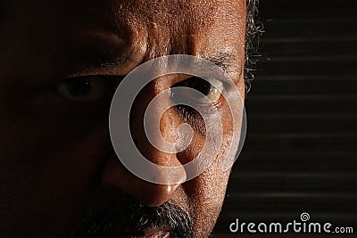 Criminal looking with intense eye expression Stock Photo