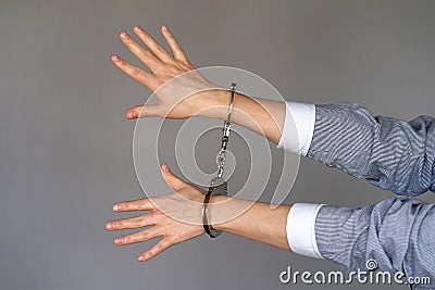 Criminal hands locked in handcuffs. Stock Photo